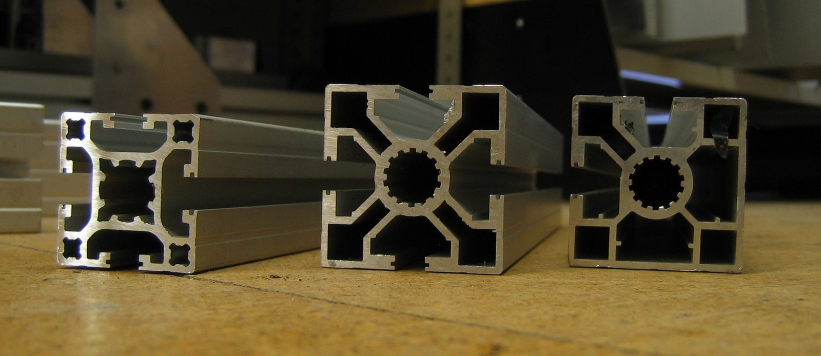 Photograph of three real aluminium extrusion profiles