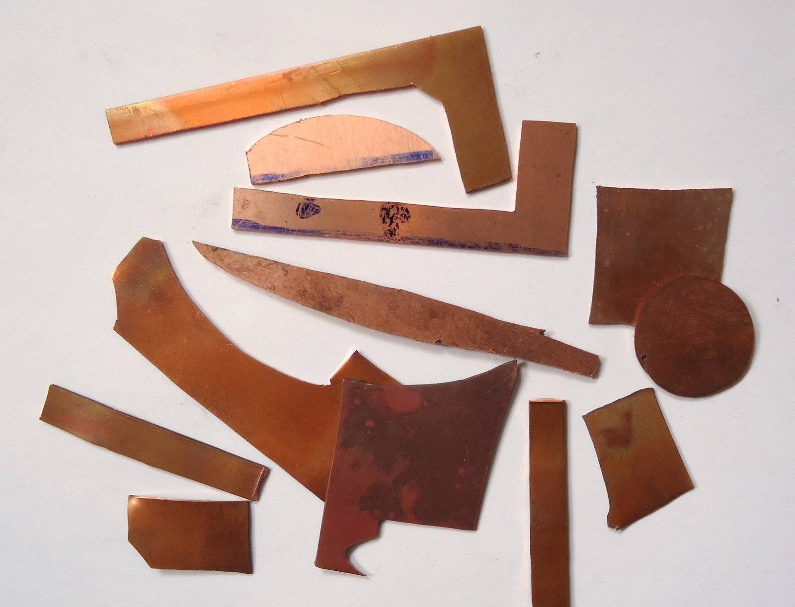 Photograph of copper sheet offcuts in varied shapes